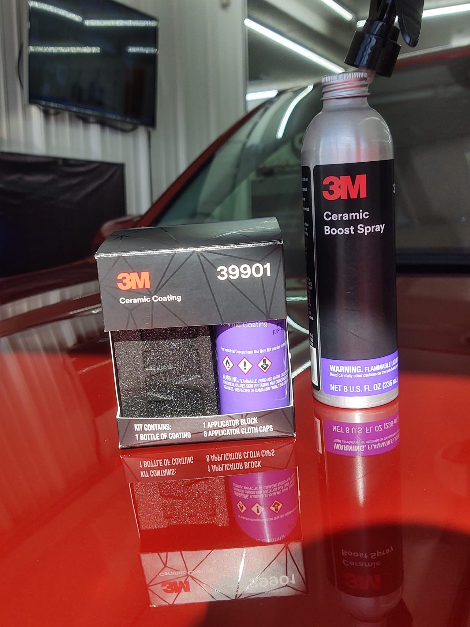 3M Ceramic Coating kit and Ceramic Boost Spray displayed on glossy red car hood